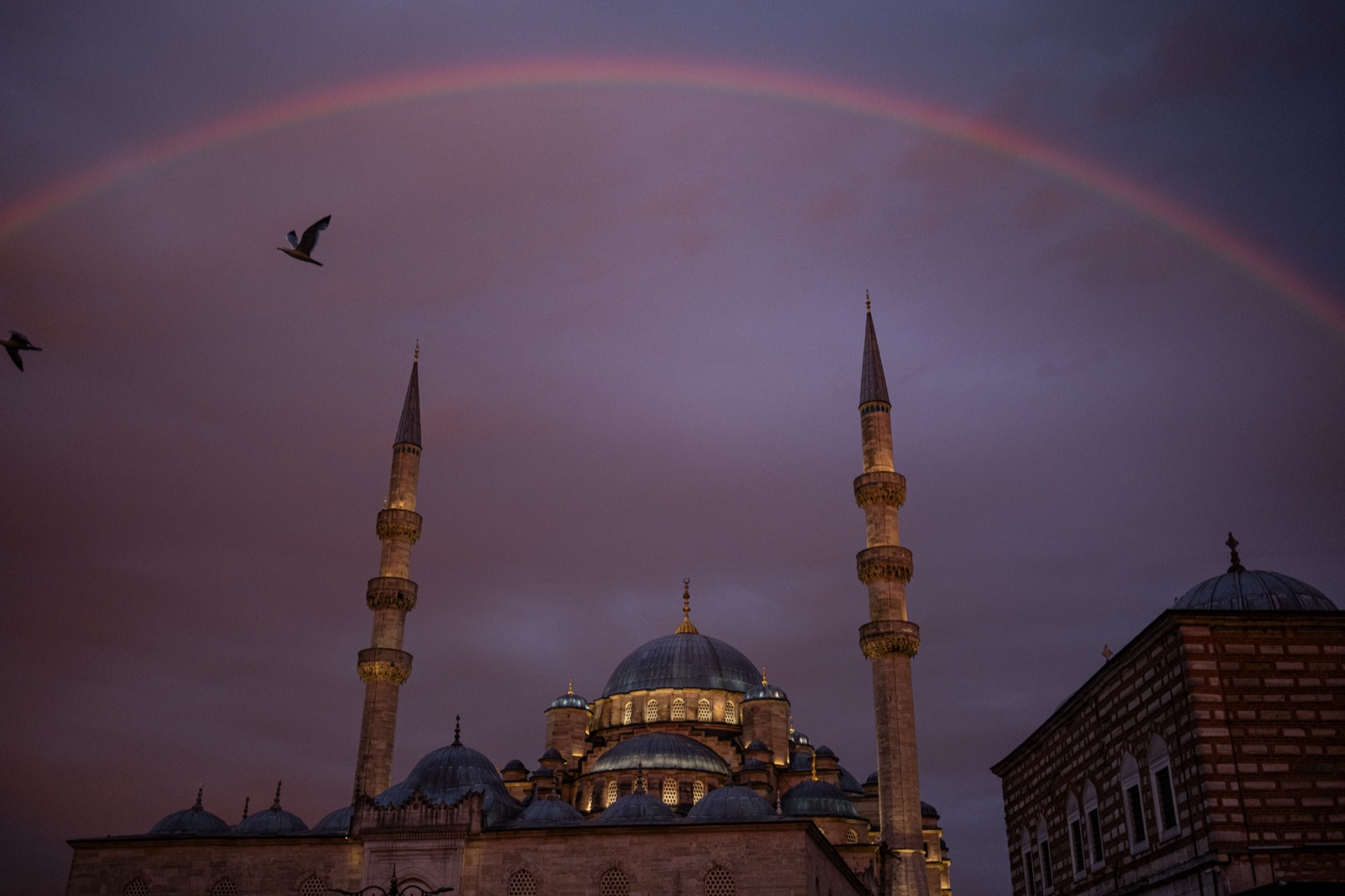 A rainbow over the New Mosque at dusk, with gulls