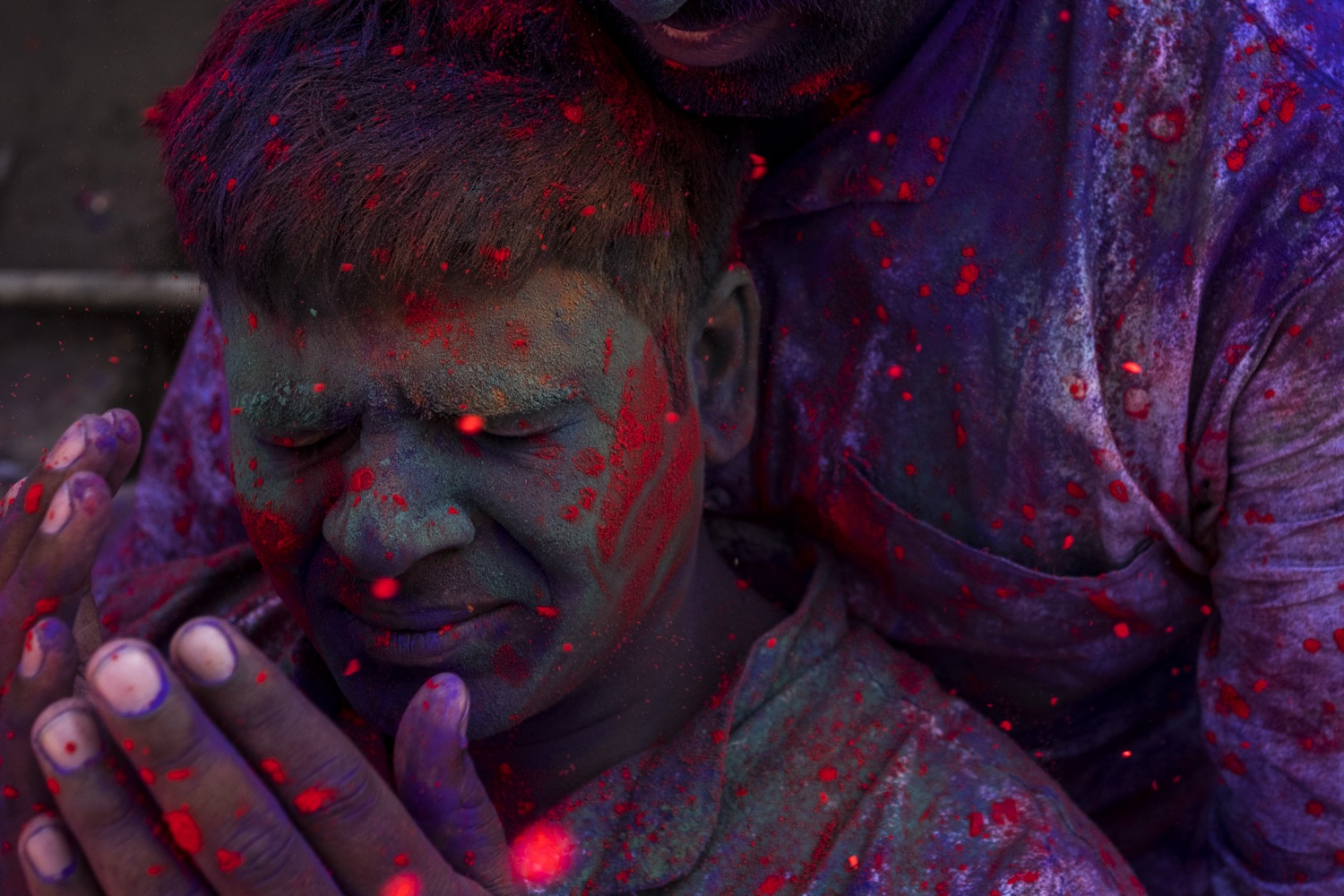 Faces covered in red and blue powder, Holi