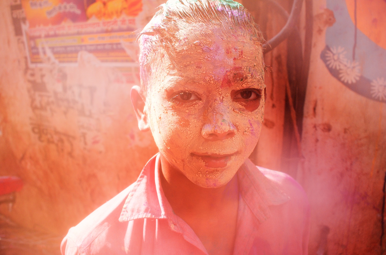 Boy covered in colour powder during Holi